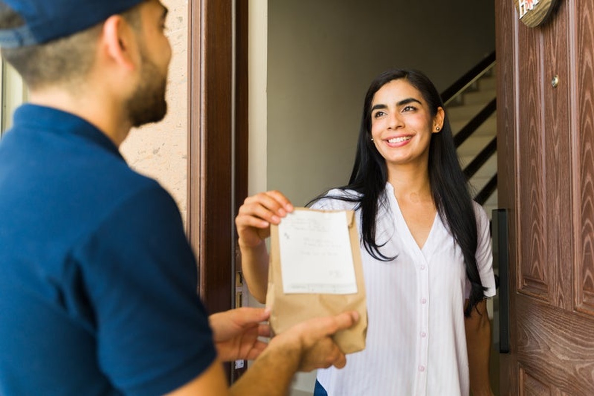 A patient receiving a prescription at their door