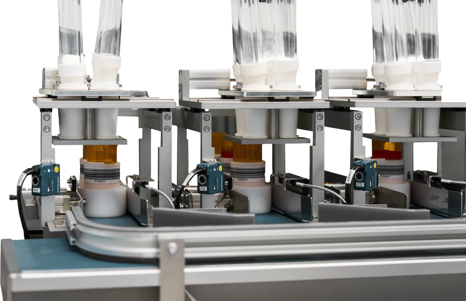 Vials moving along the high-volume conveyor past inline scanners and capping stations